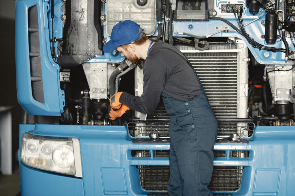 man-with-tools-truck-worker-uniform-faulty-truck-min