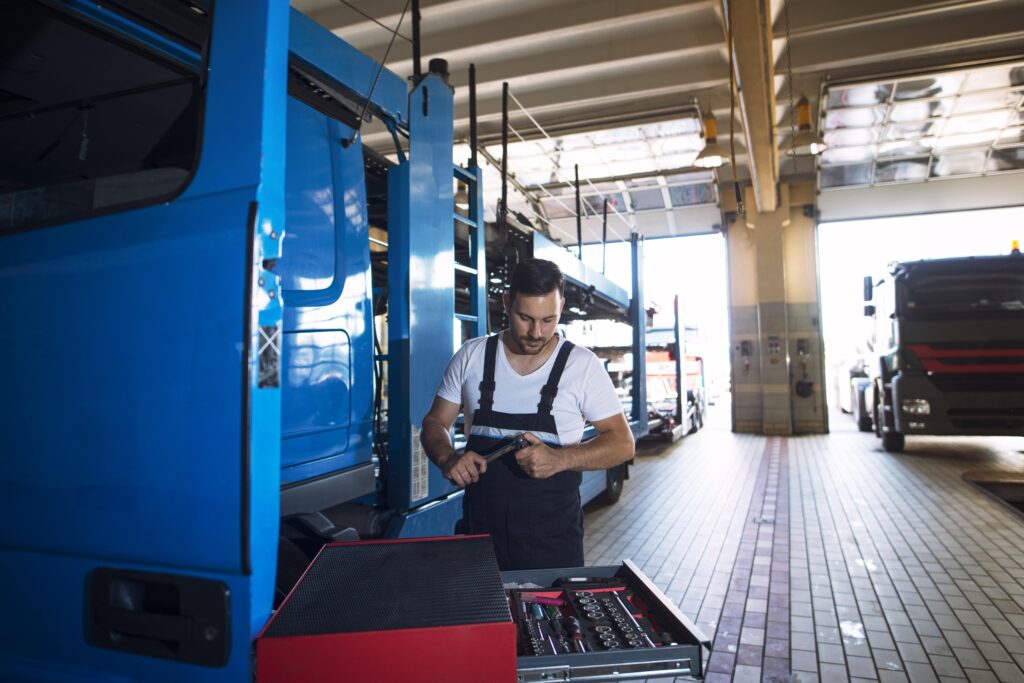 truck-mechanic-servicing-truck-vehicle-workshop-min